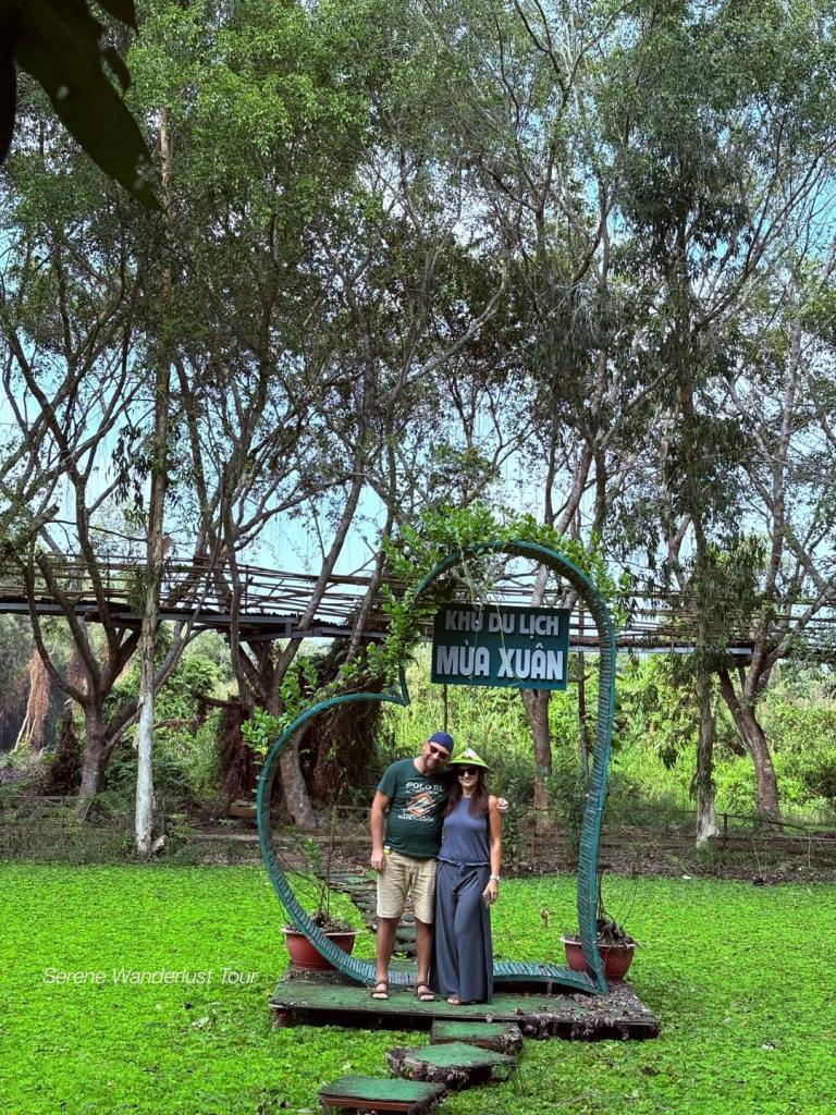 A wooden archway marking the entrance to Lung Ngoc Hoang Nature Reserve in Can Tho, Vietnam.