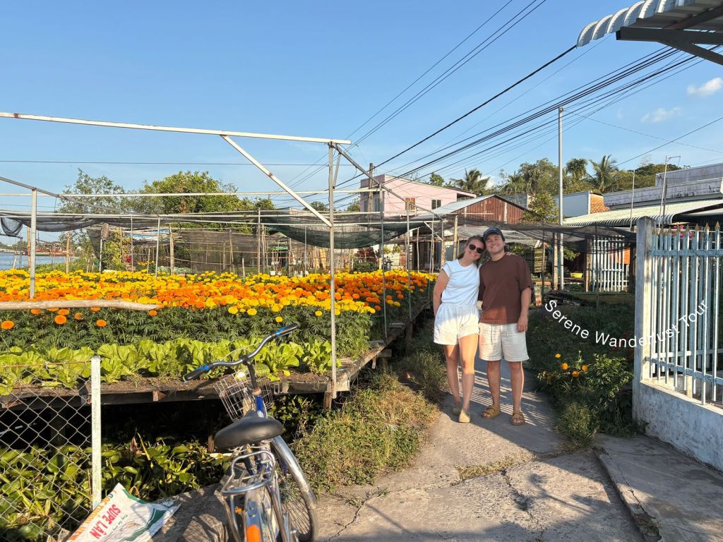 Scenic flower garden by the river on Can Tho cycling tour.